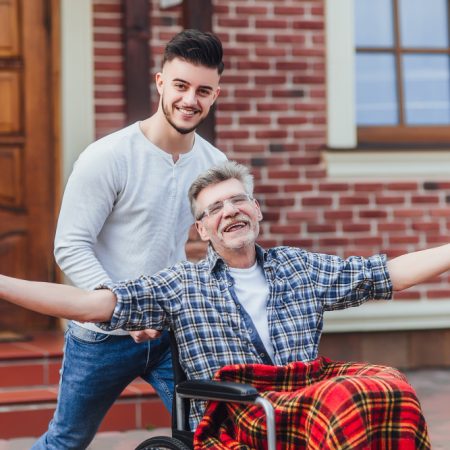 senior-father-wheelchair-young-son-walk